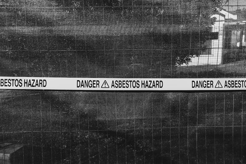 Warning sign highlighting the dangers of asbestos exposure.