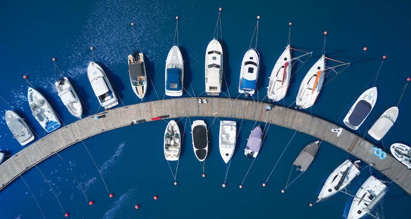 Banner showing a fleet of boats and yachts on the water.