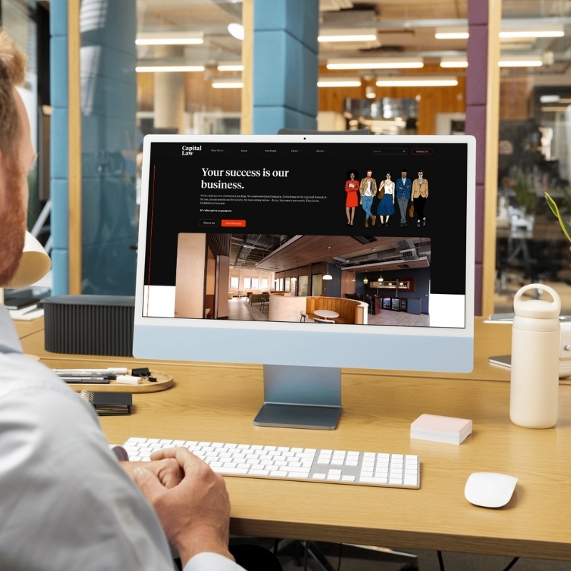 Computer screen mockup presenting the Capital Law website layout.