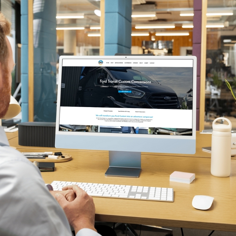 Computer screen mockup presenting the Hideaway Campervans website layout.