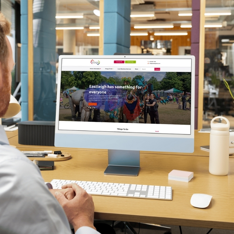 Computer screen mockup presenting the Visit Eastleigh website layout.