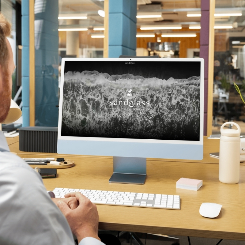Computer screen mockup presenting the YNV Group website design.