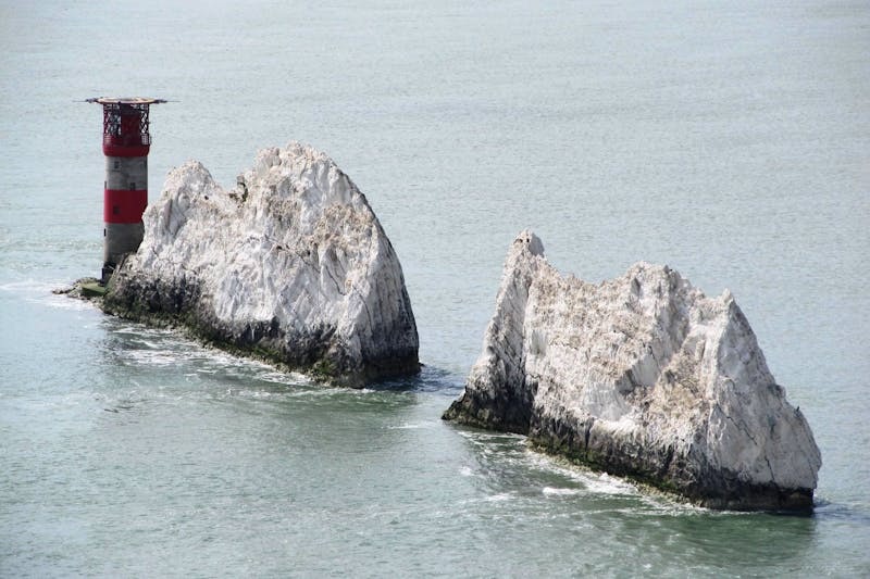 The Needles chalk cliffs and lighthouse on the Isle of Wight coastline.
