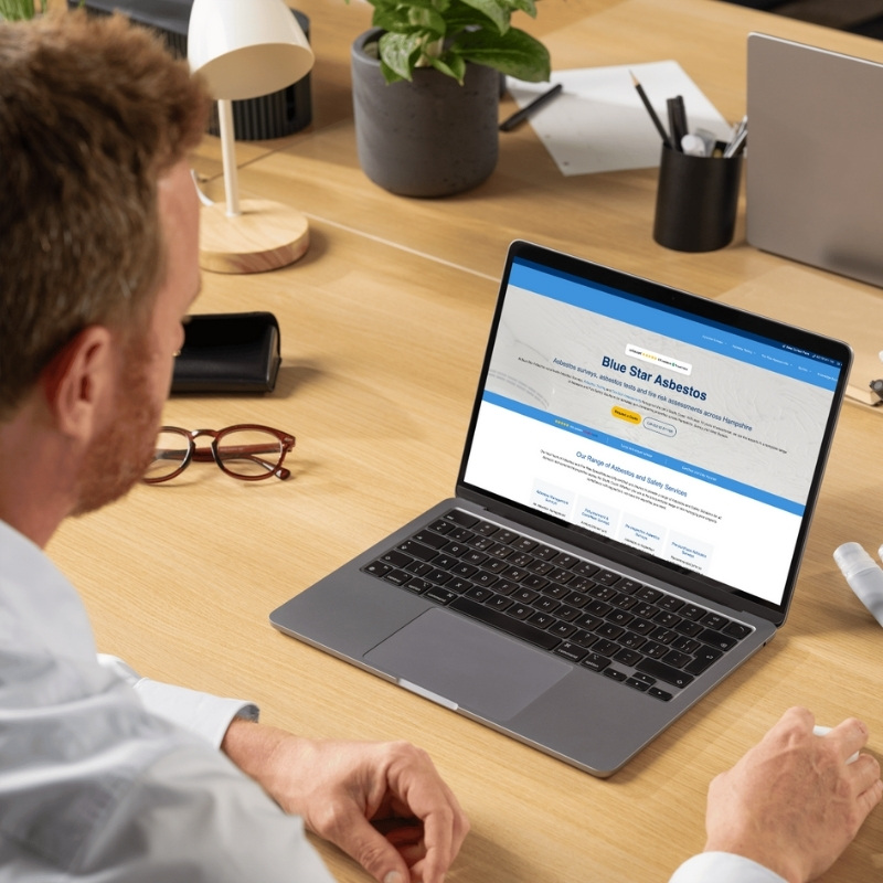 Laptop mockup showcasing the Blue Star Asbestos website homepage.