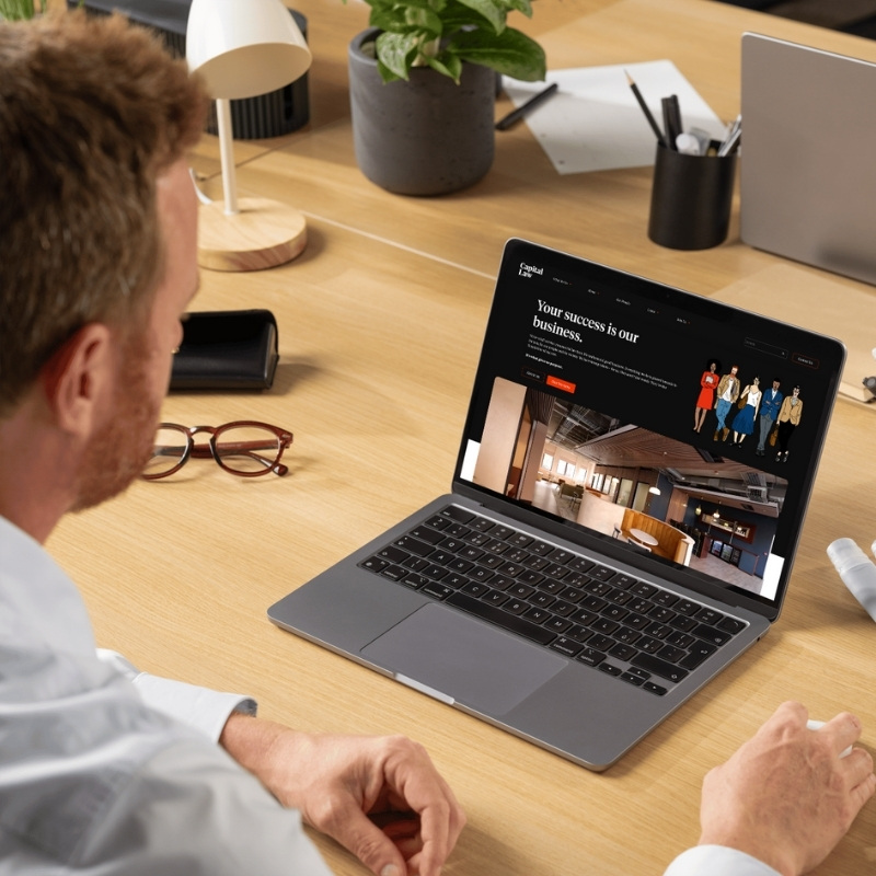 Laptop mockup showcasing the Capital Law website homepage.