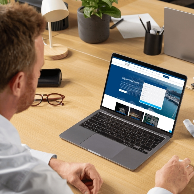 Laptop mockup showcasing the Clipper Marine website homepage.