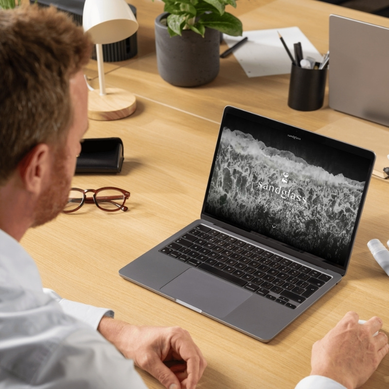 Laptop mockup displaying the YNV Group website homepage.