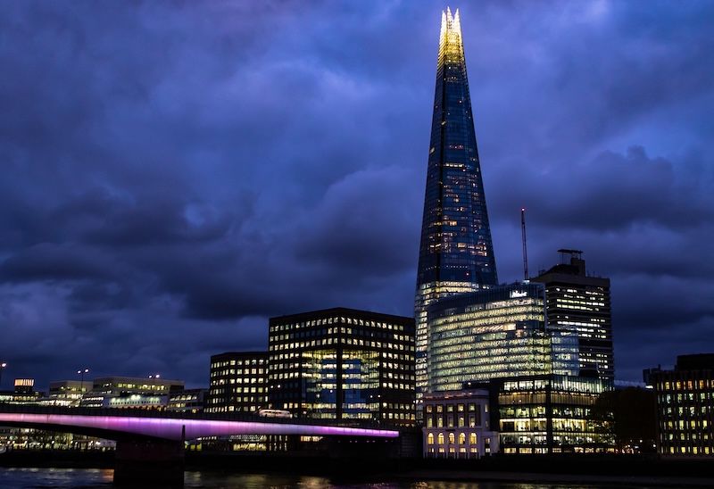 City skyline view with The Shard and surrounding buildings at sunset.