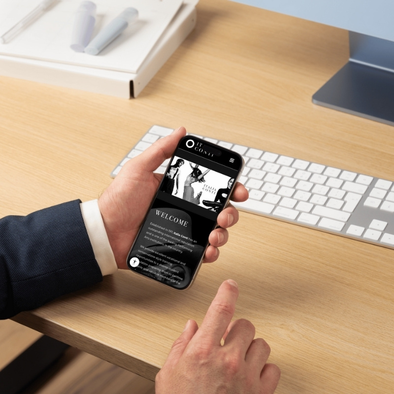 Mobile phone mockup displaying the Italia Conti website homepage.