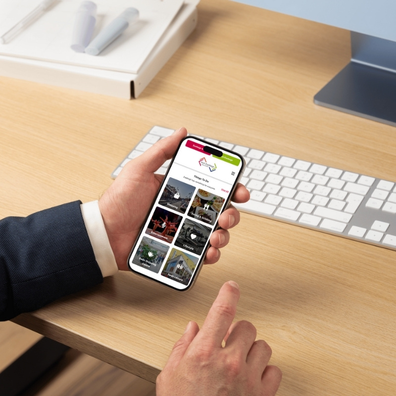 Mobile phone mockup displaying the Visit Eastleigh website homepage.
