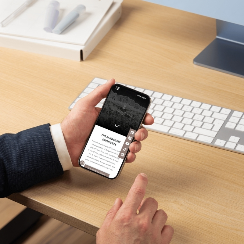 Mobile phone mockup displaying the YNV Group website homepage.