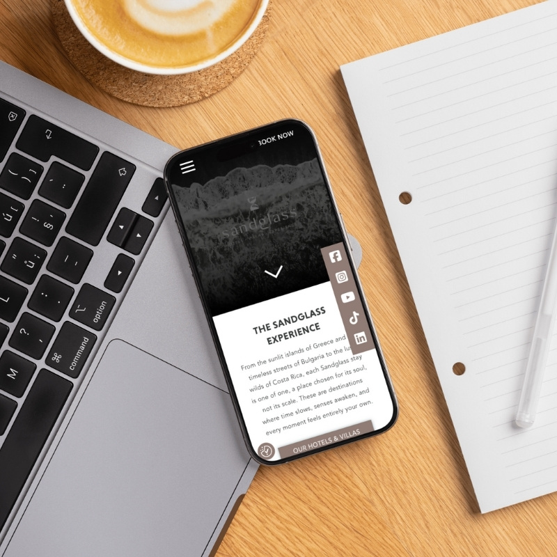 Smartphone screen mockup showing the YNV Group website design.