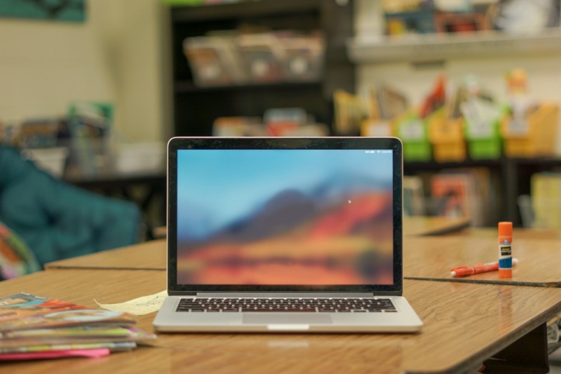 School laptop on a desk in a classroom setting.