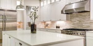 Modern bathroom with white marble surfaces and a sleek minimalist design.