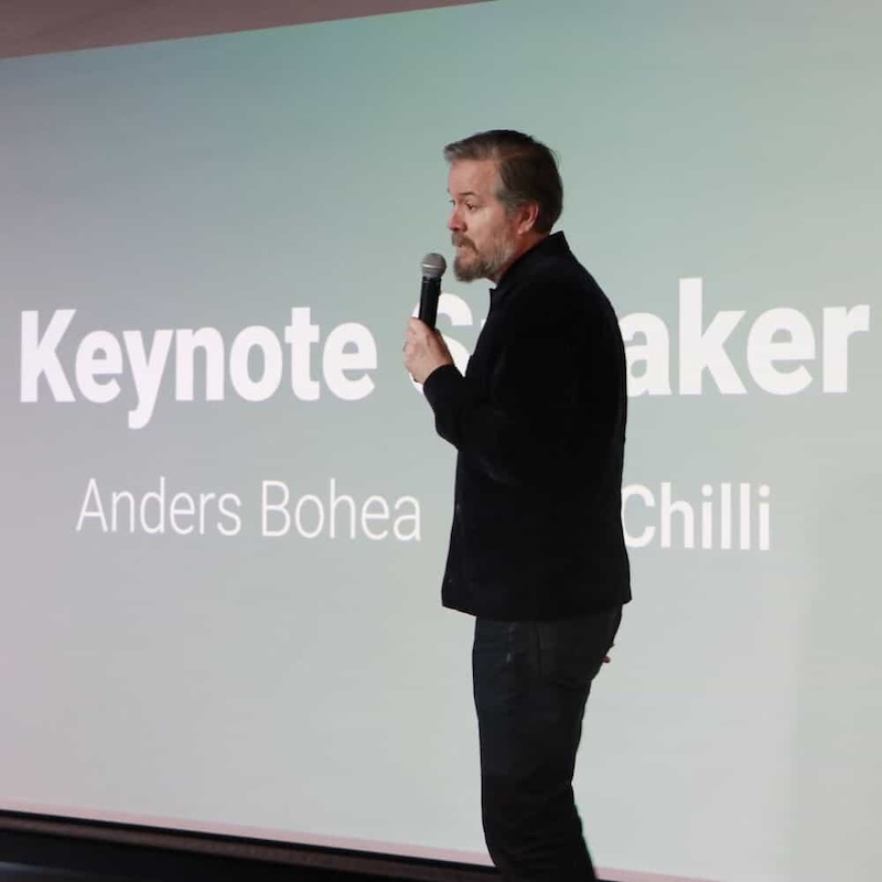 Anders delivering a keynote presentation on stage.