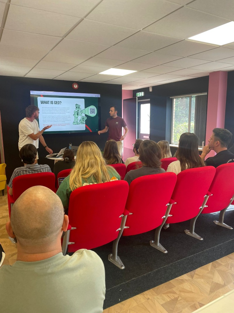 Owen and Jacob presenting Generative Engine Optimisation to an audience.